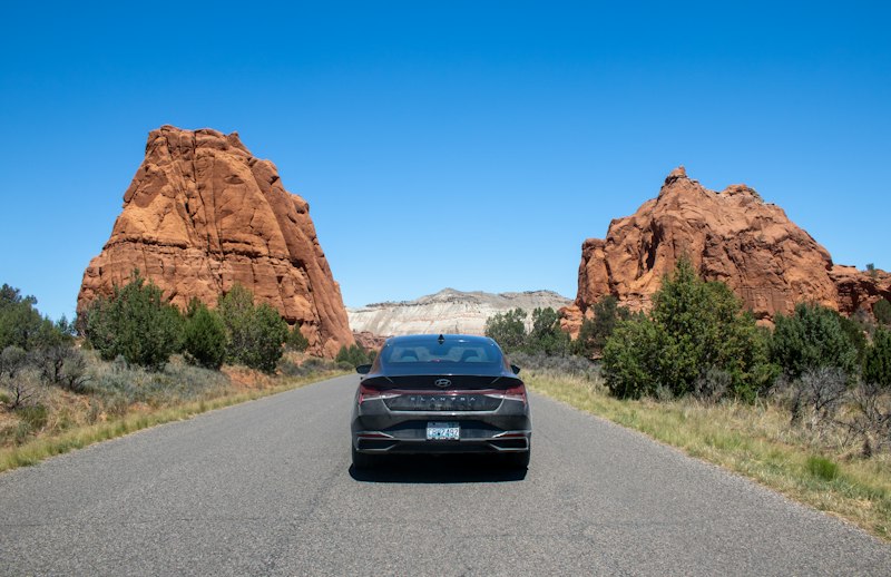 A car driving down a road in the desert